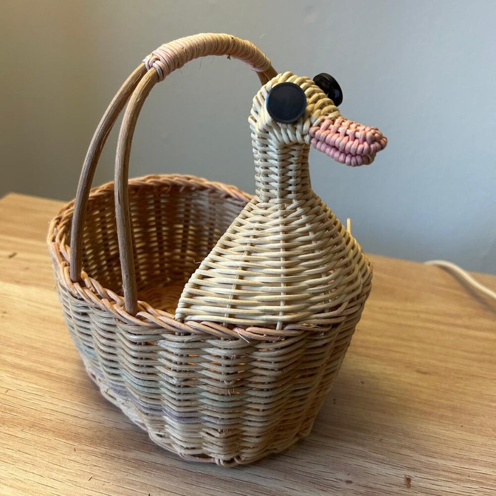 Vintage wicker duck basket, often used as decorative storage or a country-style